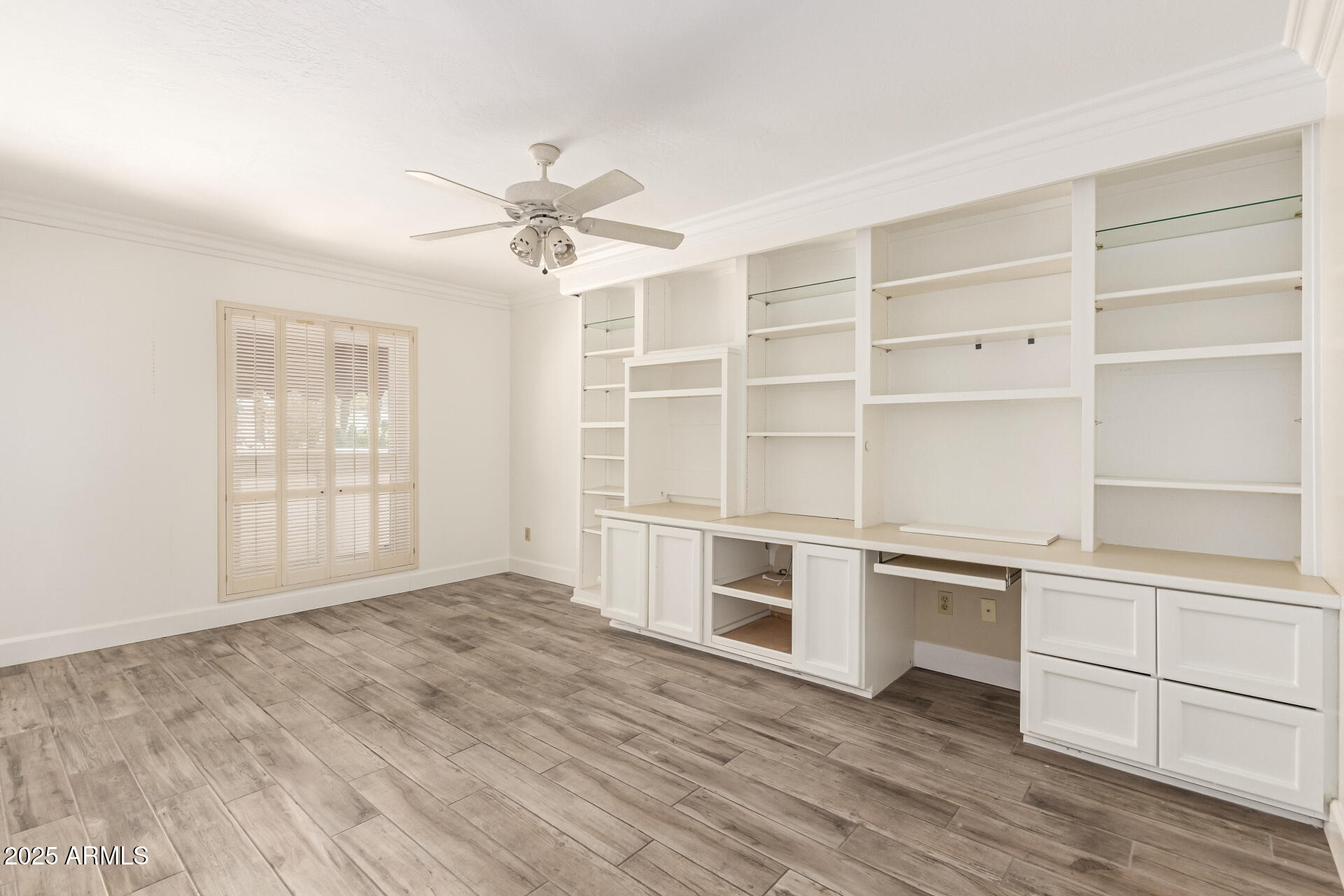38 East Calavar Road Phoenix, AZ 85022 - Photo 31 of 45 a view of an empty room with a window and wooden floor