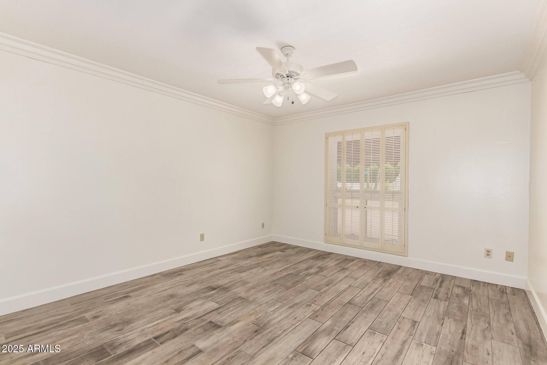 38 East Calavar Road Phoenix, AZ 85022 - Photo 32 of 45 an empty room with wooden floor fan and windows