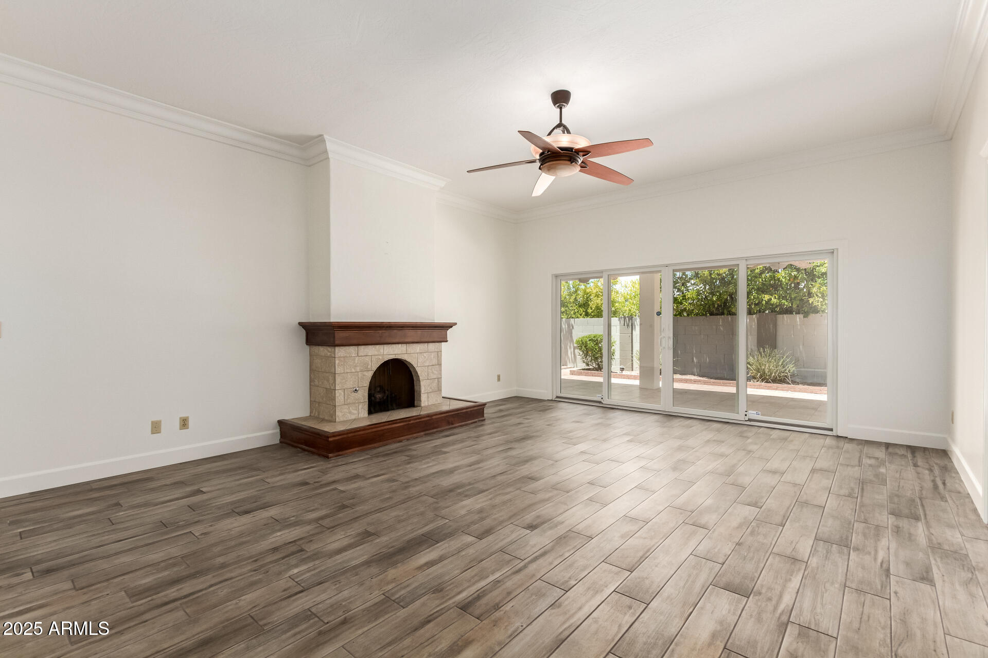 38 East Calavar Road Phoenix, AZ 85022 - Photo 9 of 45 a view of empty room with wooden floor and fireplace