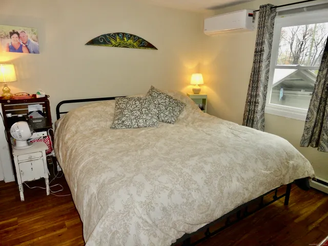 a large bed sitting in a bedroom next to a window