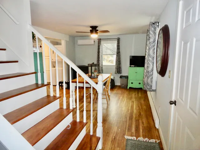 a view of entryway and hall with wooden floor