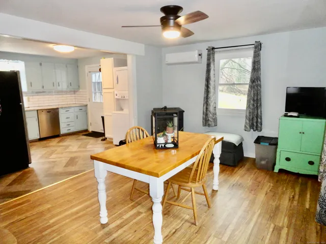 a view of a dining room with furniture window and wooden floor