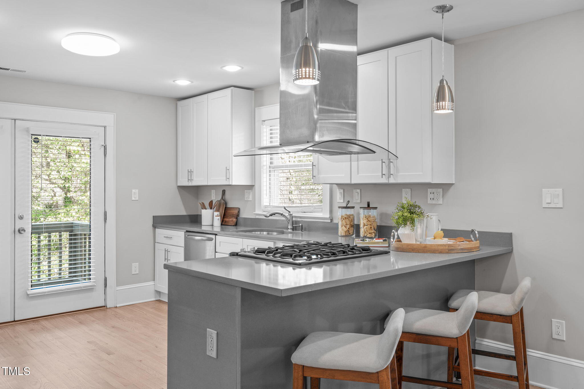 1900 Sunset Avenue Durham, NC 27705 - Photo 20 of 53 a kitchen with stainless steel appliances granite countertop a sink a stove a window and white cabinets