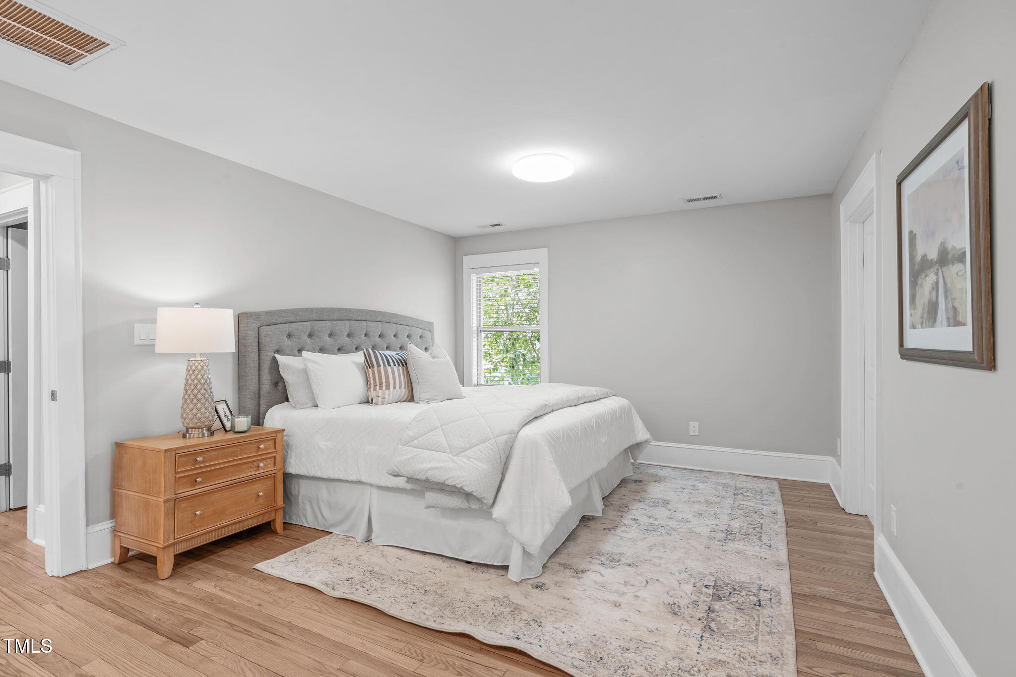 1900 Sunset Avenue Durham, NC 27705 - Photo 27 of 53 a bedroom with a bed and wooden floor