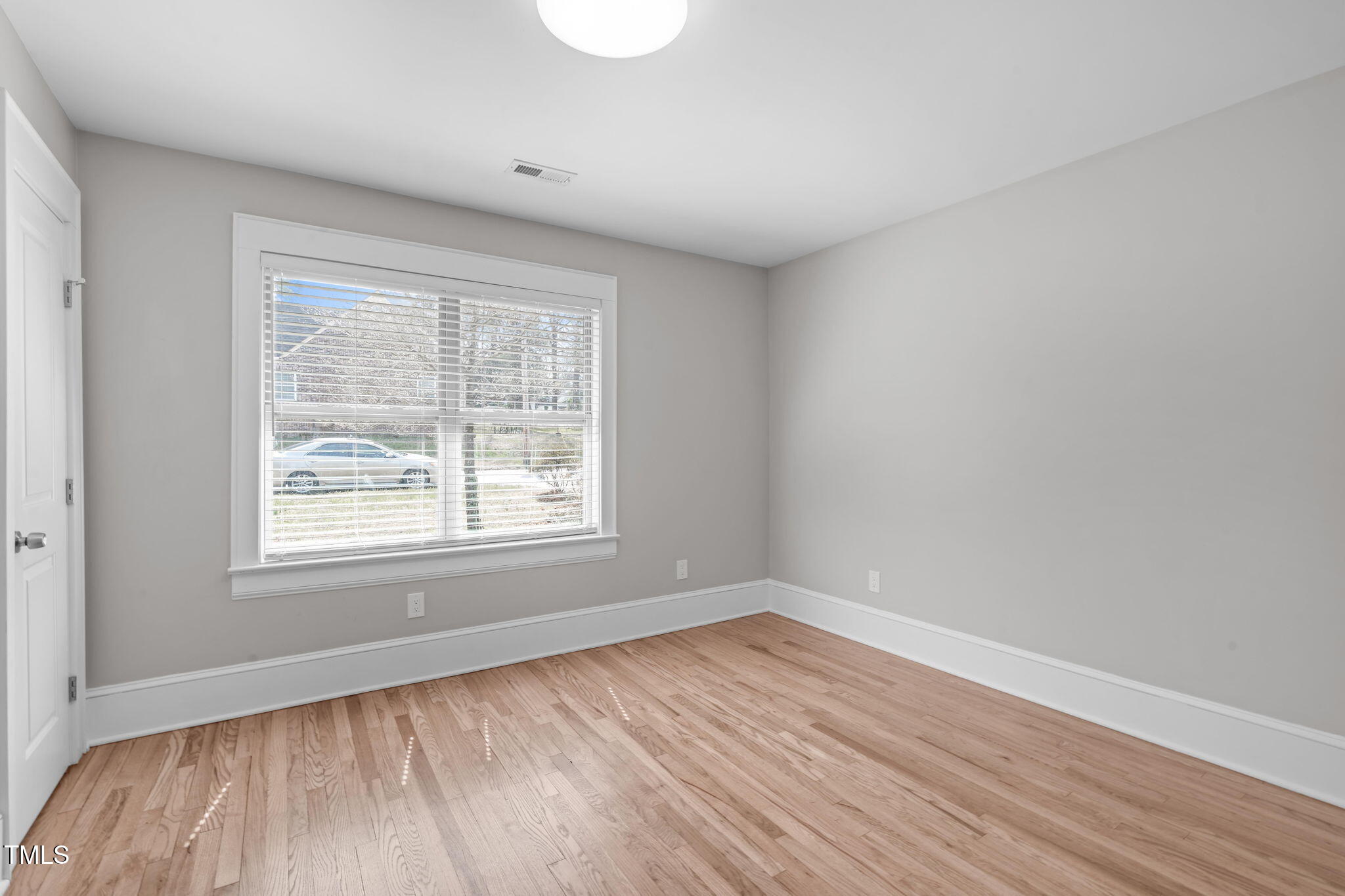 1900 Sunset Avenue Durham, NC 27705 - Photo 36 of 53 a view of an empty room with wooden floor and a window