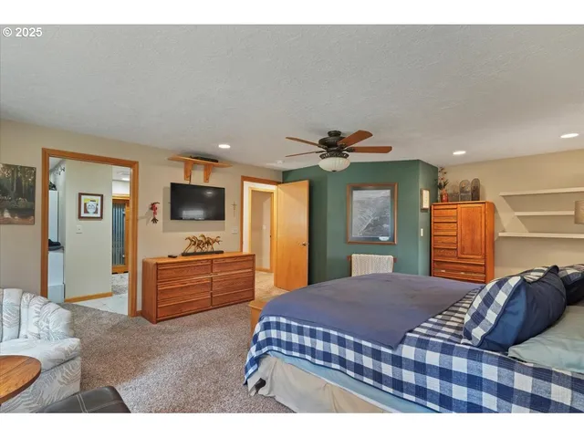 a bedroom with a large bed and a flat screen television