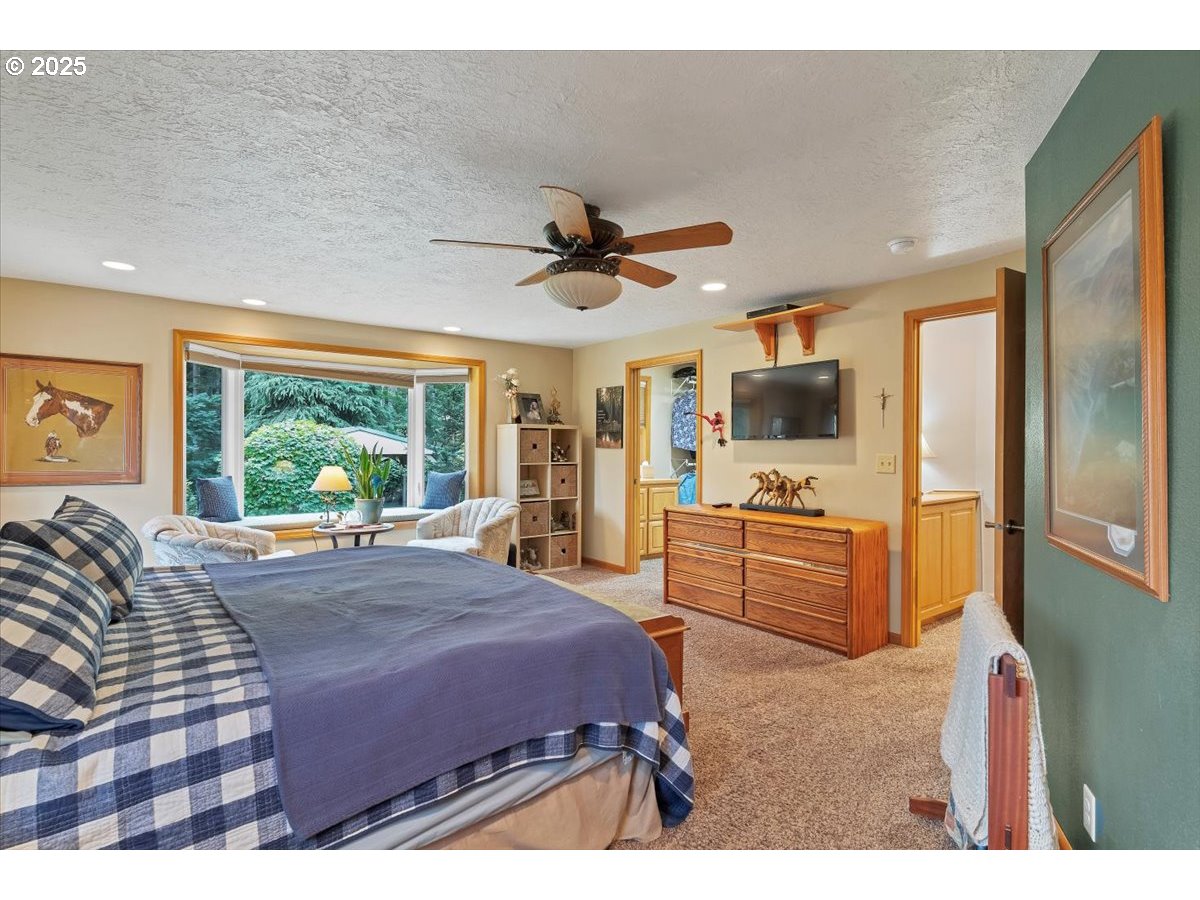 9076 Daleview Road Southeast Salem, OR 97317 - Photo 21 of 45 a bed room with a bed television and a large window