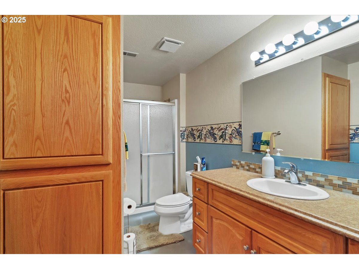 9076 Daleview Road Southeast Salem, OR 97317 - Photo 29 of 45 a bathroom with a sink a toilet and shower