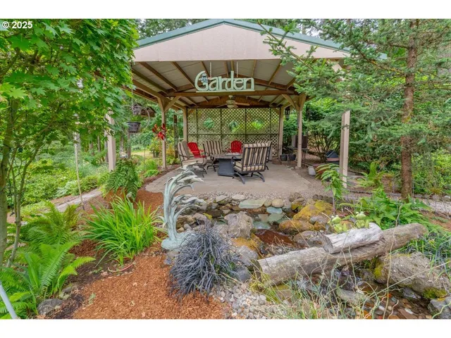 a view of a patio with table and chairs under an umbrella