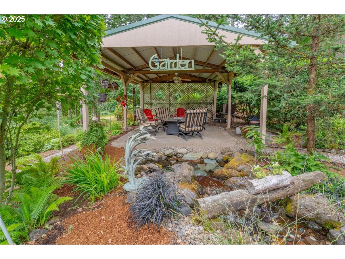 9076 Daleview Road Southeast Salem, OR 97317 - Photo 34 of 45 a view of a patio with table and chairs under an umbrella