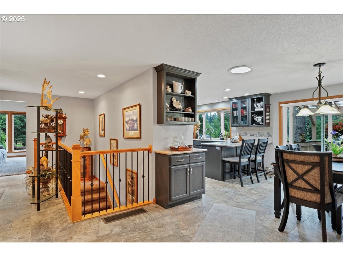 9076 Daleview Road Southeast Salem, OR 97317 - Photo 9 of 45 a open kitchen with stainless steel appliances kitchen island granite countertop a table and chairs