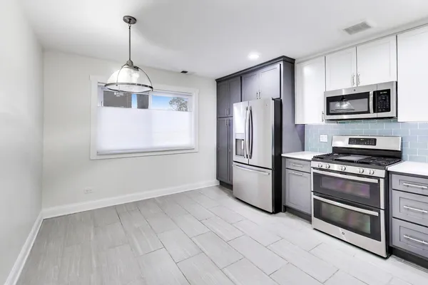 a kitchen with stainless steel appliances a refrigerator sink and microwave