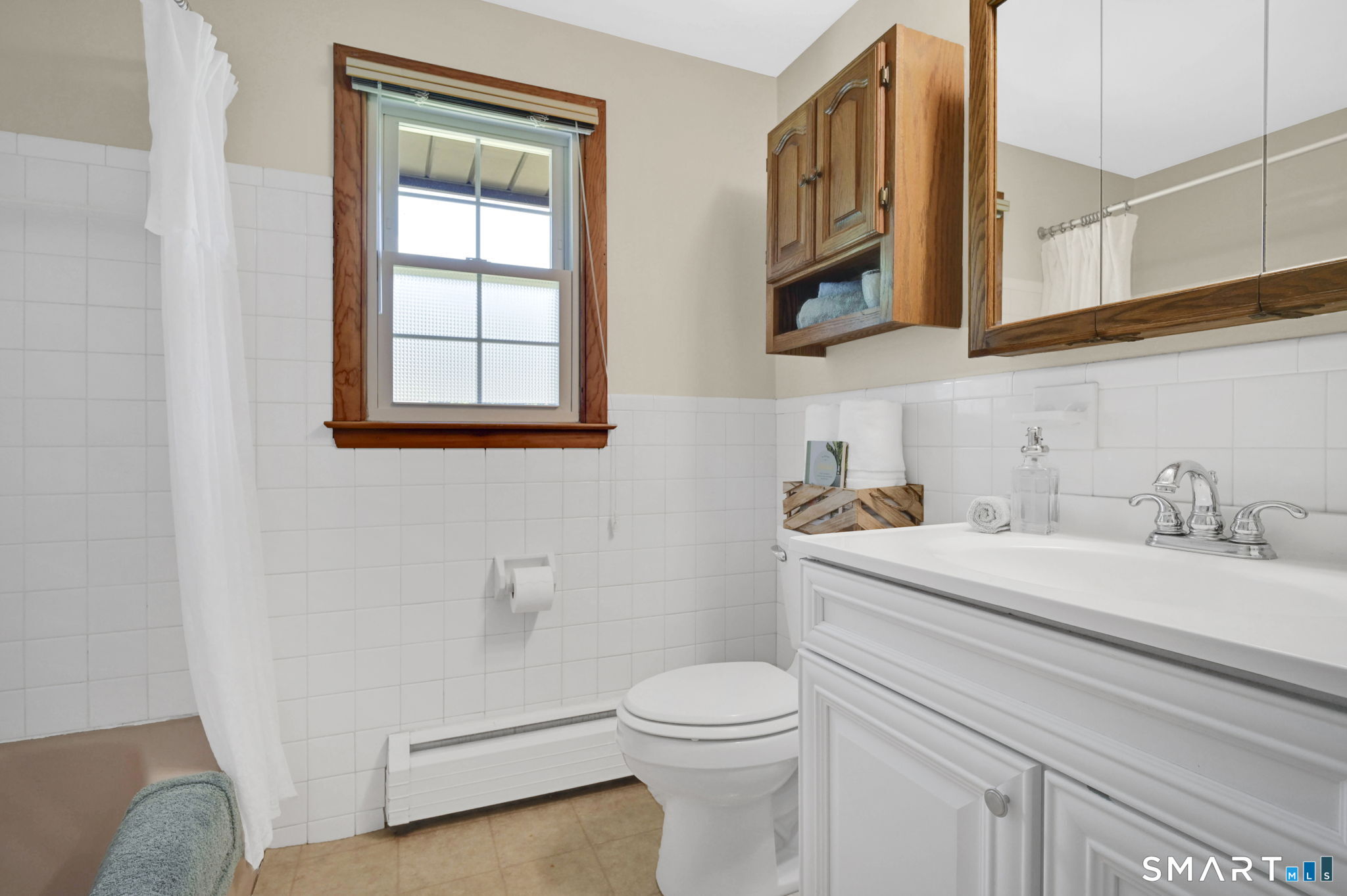 296 Phoenix Street Vernon, CT 06066 - Photo 21 of 34 a bathroom with a sink a toilet and a mirror