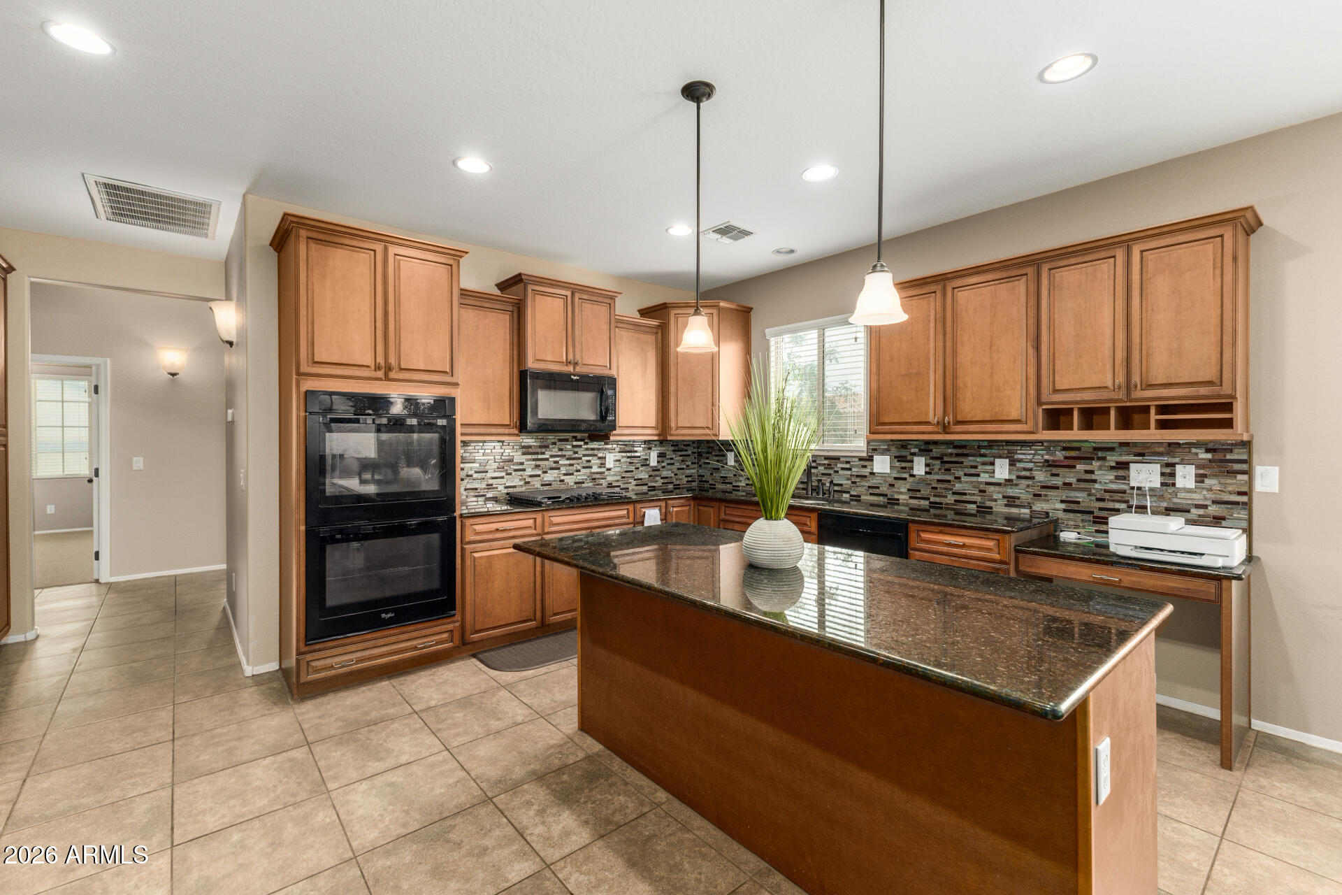 5718 West Pecan Road Laveen, AZ 85339 - Photo 11 of 37 a kitchen with stainless steel appliances granite countertop a stove a sink and a refrigerator