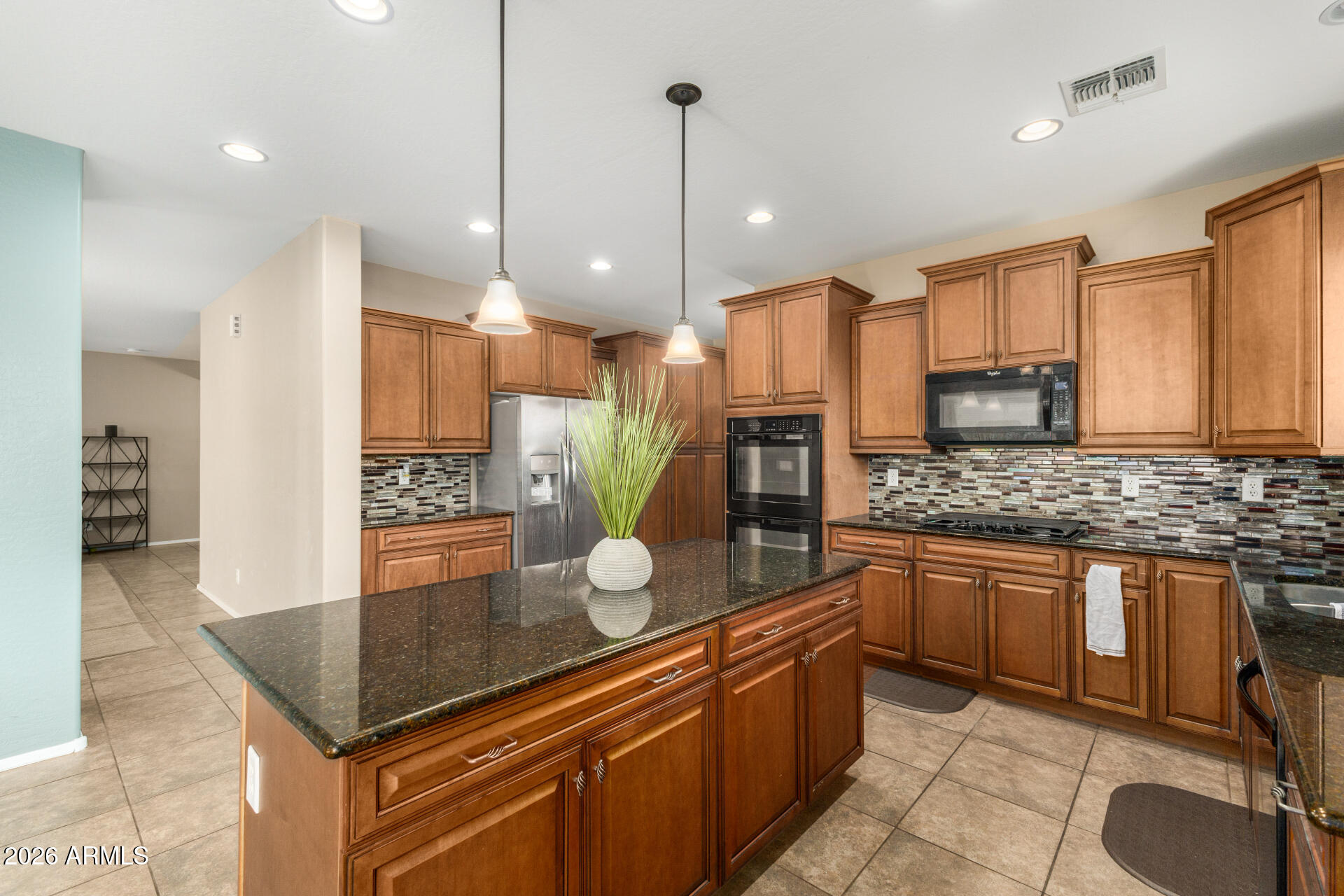5718 West Pecan Road Laveen, AZ 85339 - Photo 12 of 37 a kitchen with stainless steel appliances granite countertop a stove a sink and a refrigerator