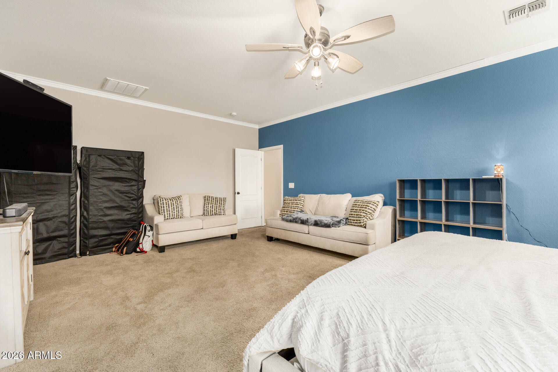 5718 West Pecan Road Laveen, AZ 85339 - Photo 19 of 37 a spacious bedroom with a bed and a flat screen tv