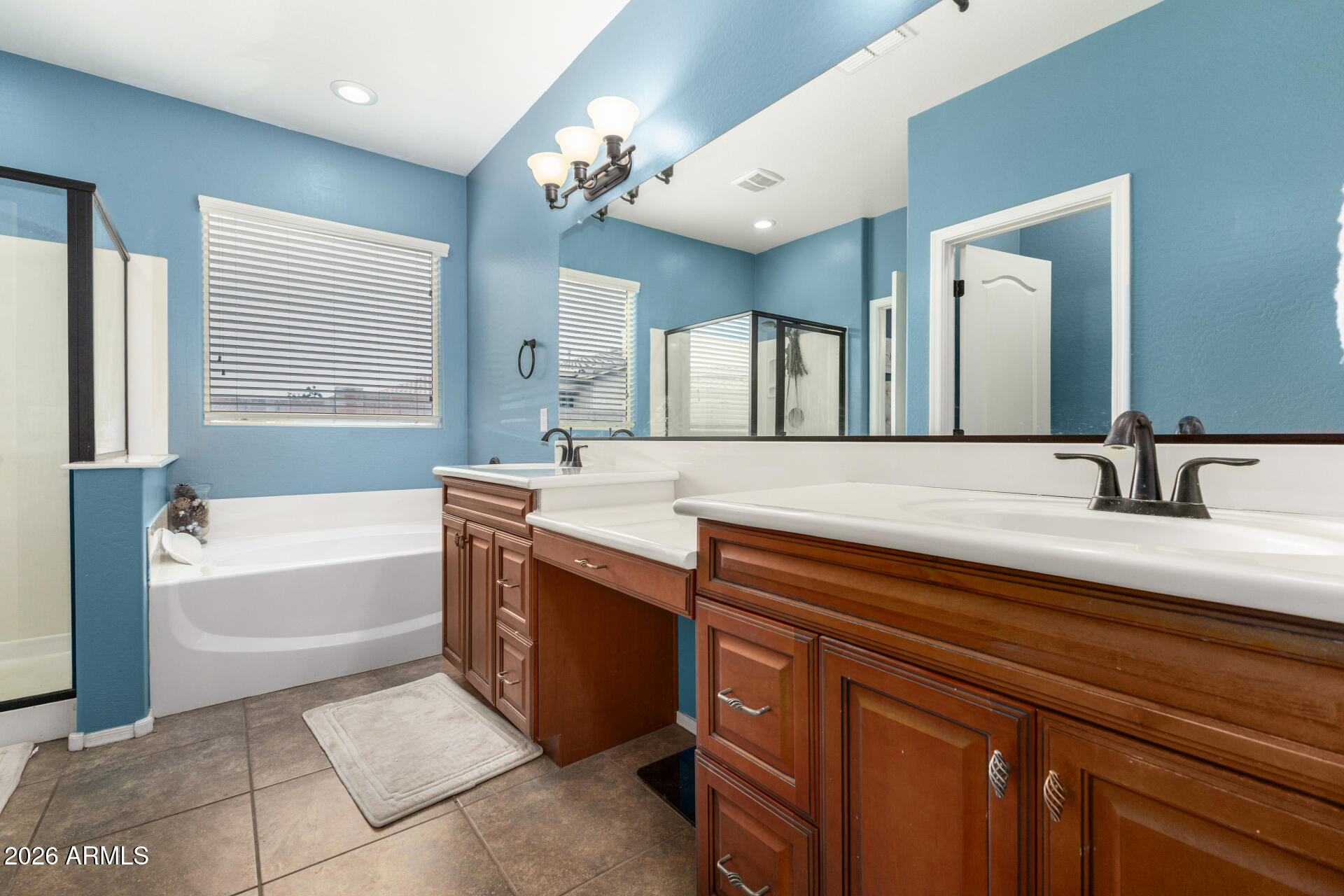 5718 West Pecan Road Laveen, AZ 85339 - Photo 21 of 37 a spacious bathroom with a bathtub sink and mirror