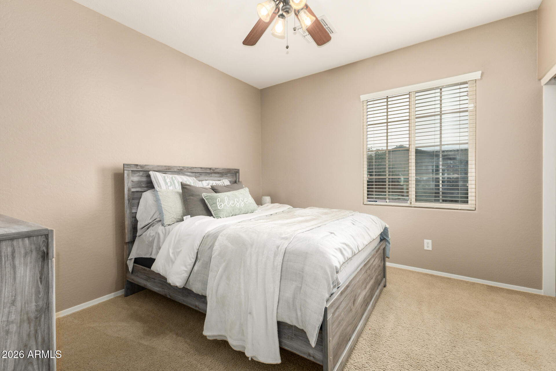 5718 West Pecan Road Laveen, AZ 85339 - Photo 25 of 37 a bed sitting in a bedroom next to a window