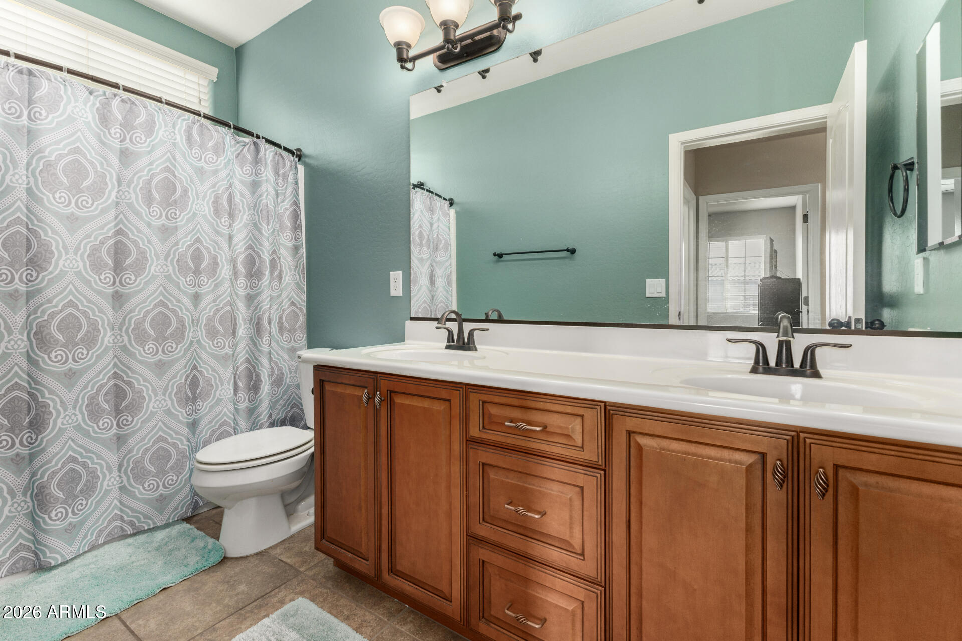 5718 West Pecan Road Laveen, AZ 85339 - Photo 27 of 37 a bathroom with a double vanity sink toilet and a mirror
