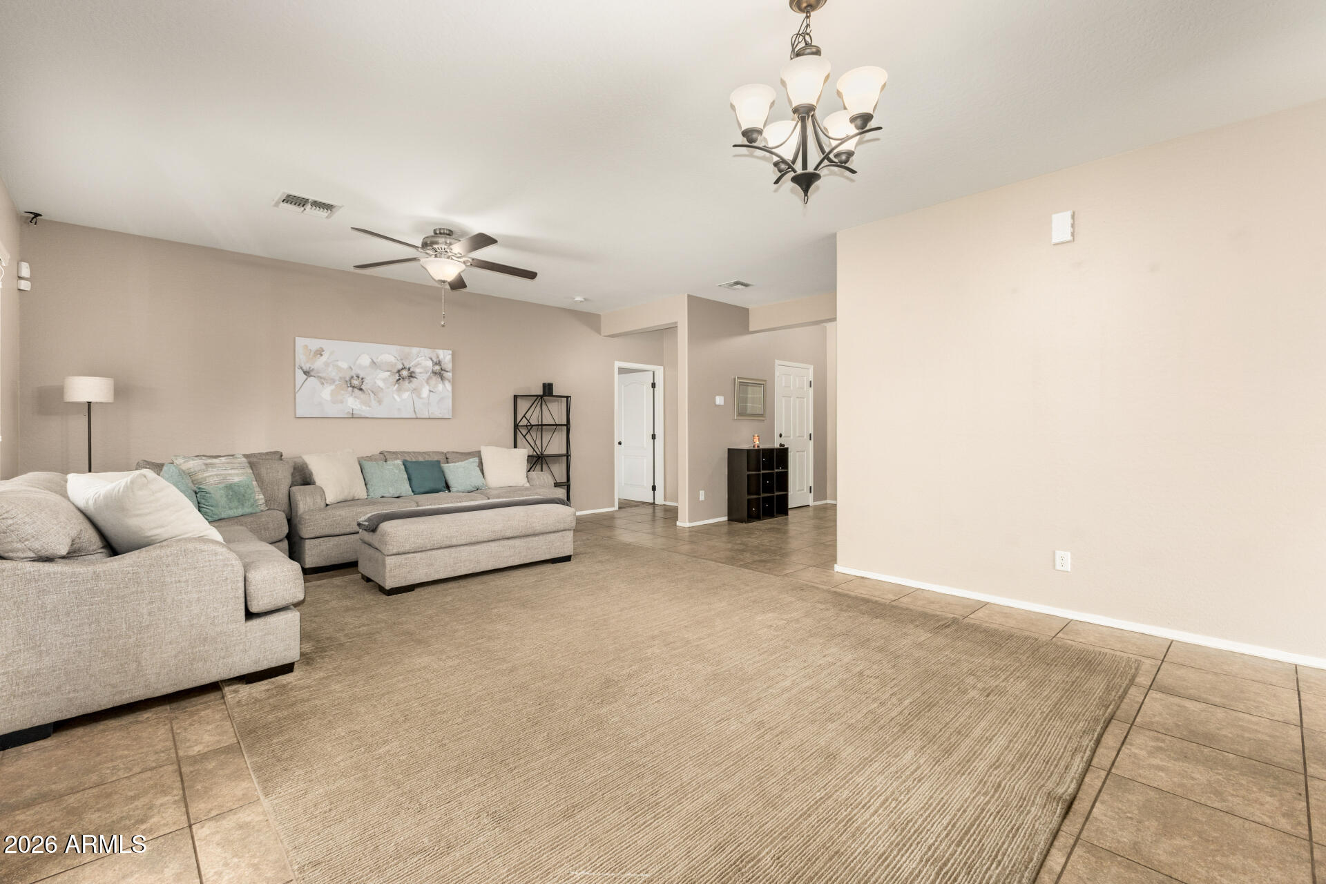 5718 West Pecan Road Laveen, AZ 85339 - Photo 7 of 37 a living room with furniture and a chandelier