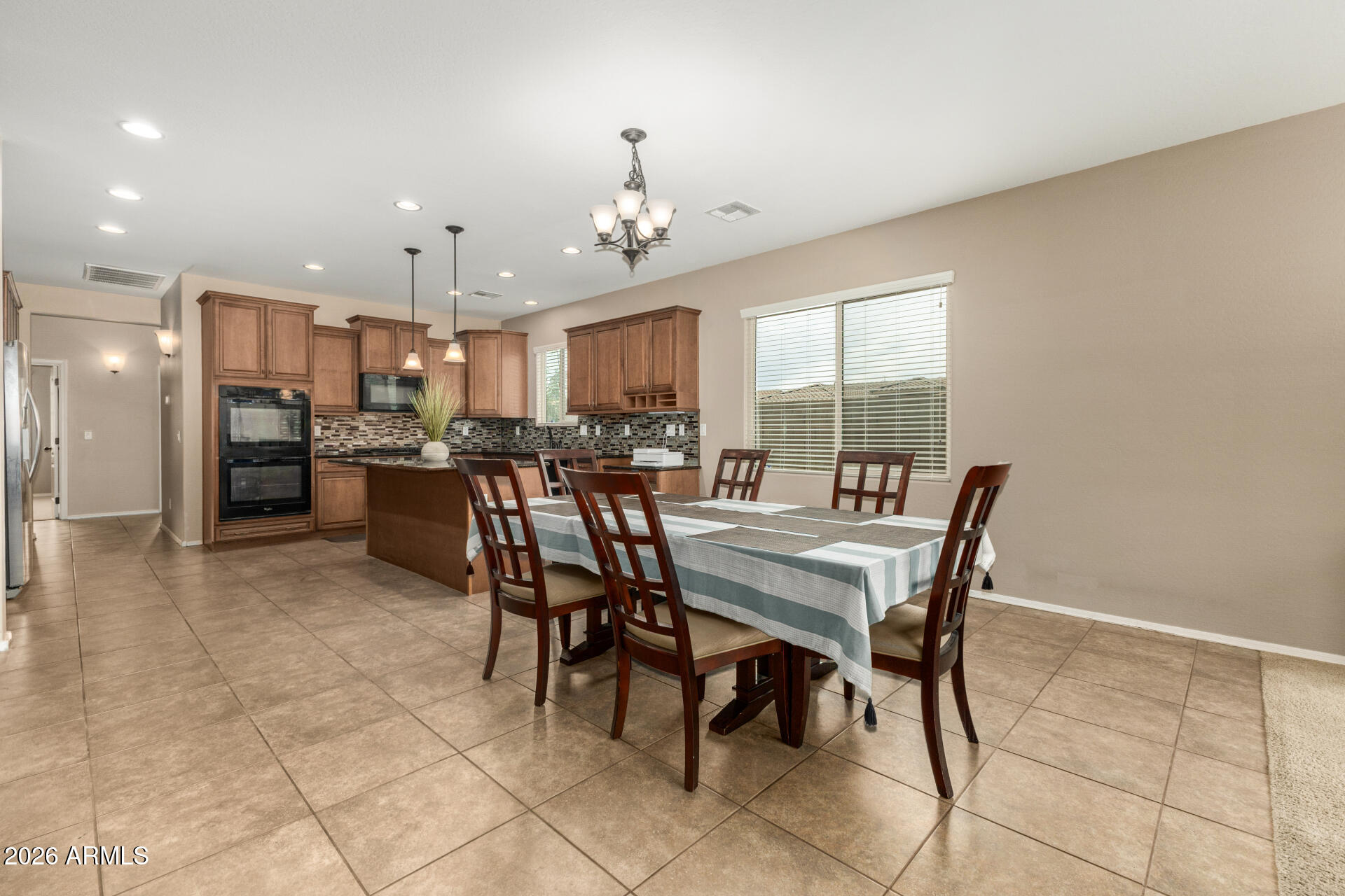 5718 West Pecan Road Laveen, AZ 85339 - Photo 10 of 37 a view of a dining room with furniture and a chandelier