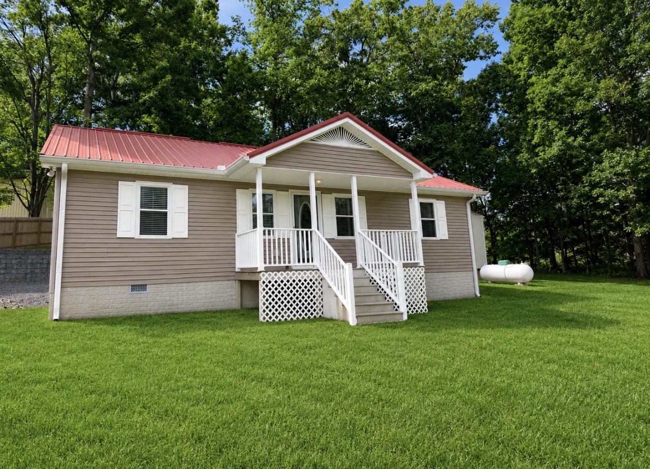 153 Henry Harris Road Westmoreland, TN 37186 - Photo 2 of 18 a front view of a house with a yard and fence