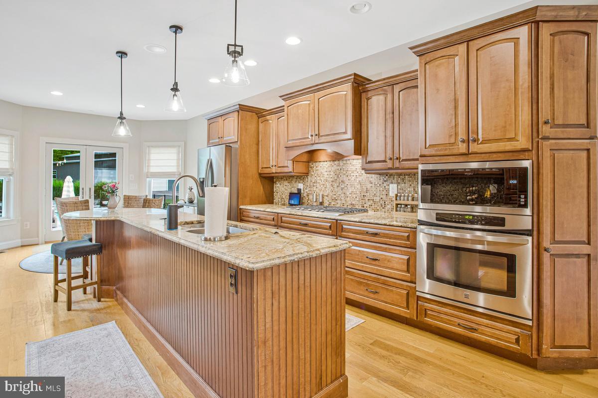 5 Jessie Road Harwood, MD 20776 - Photo 31 of 87 a kitchen with stainless steel appliances granite countertop a sink a stove and a refrigerator