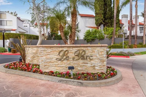 two windows and a yard in front of the house