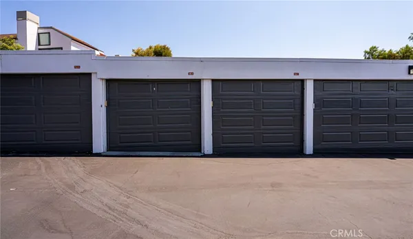 a view of a white house with a fountain and a fountain