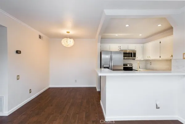 a kitchen with stainless steel appliances a refrigerator sink and microwave