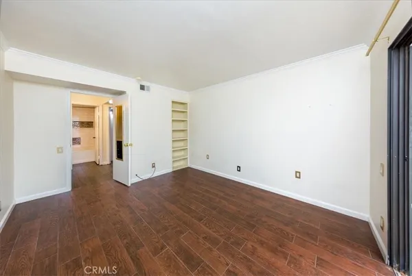 an empty room with wooden floor