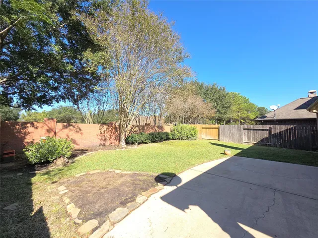 a view of yard with swimming pool and green space