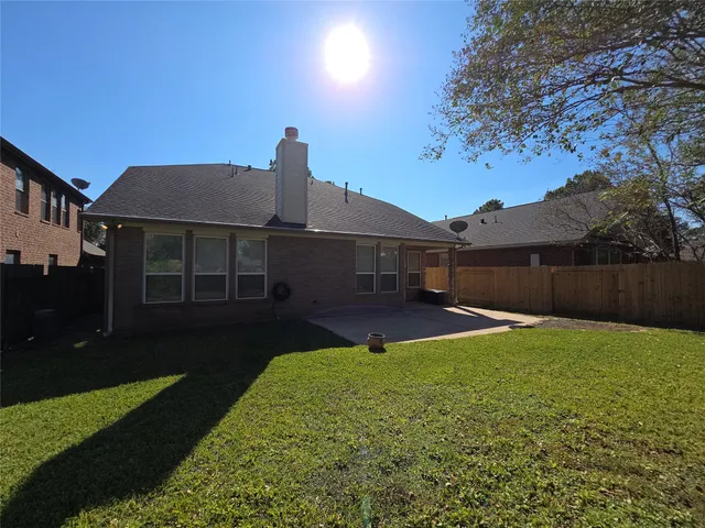 a front view of a house with yard and green space