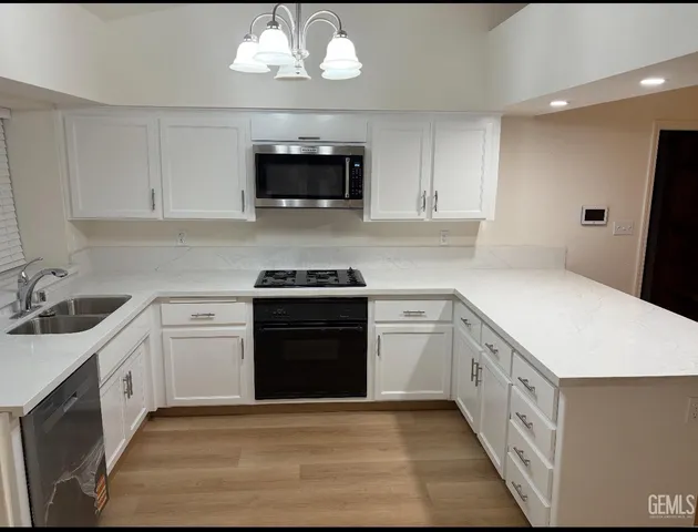 a kitchen with stainless steel appliances a stove microwave and cabinets