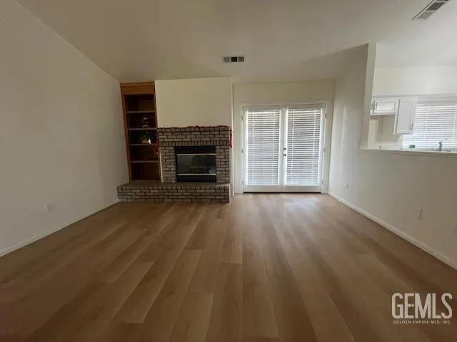 a view of kitchen with furniture and wooden floor