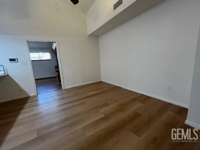 a view of an empty room and wooden floor