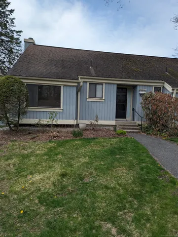 a front view of house with yard and green space
