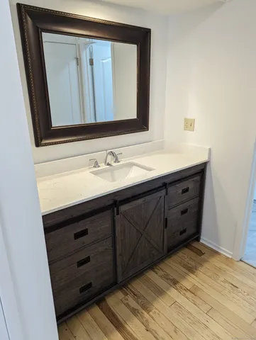 a bathroom with a sink vanity and mirror