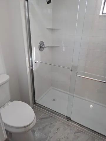 a bathroom with a glass shower door