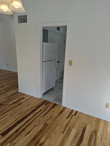 a view of a room with wooden floor