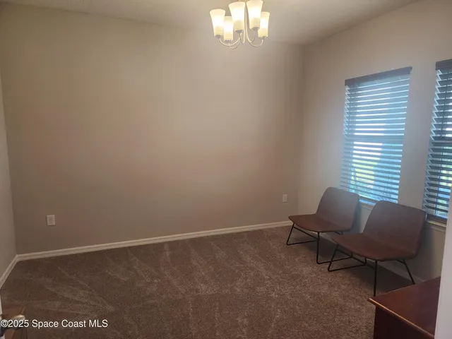 a view of a room with windows and lounge chair
