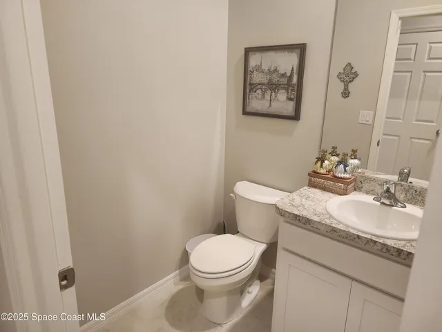 a bathroom with a toilet a sink and a mirror