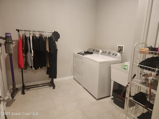 a view of walk in closet with clothes