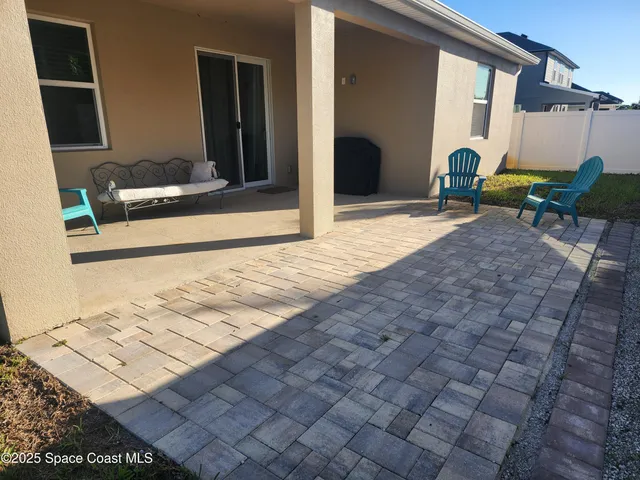 a view of backyard with swimming pool and outdoor seating