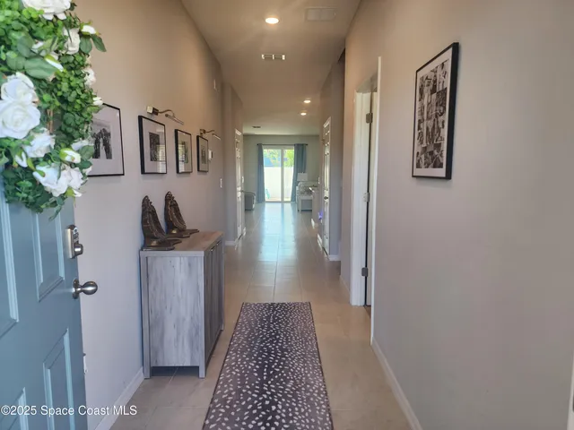 a view of hallway with livingroom and hardwood floor