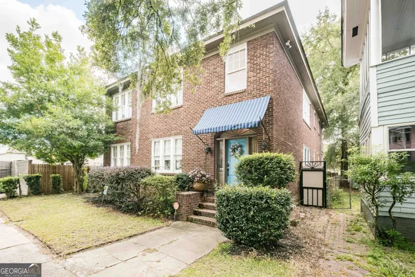 a front view of a house with garden