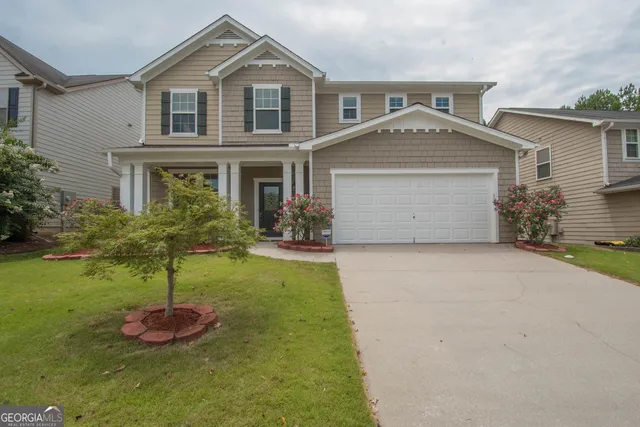 a front view of a house with a yard and garage