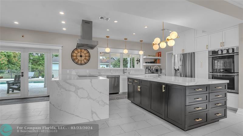 8585 Ranch Road Parkland, FL 33067 - Photo 12 of 69 a large kitchen with stainless steel appliances a large counter space and cabinets