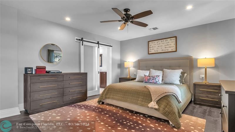 8585 Ranch Road Parkland, FL 33067 - Photo 32 of 69 a bedroom with a bed and a chandelier