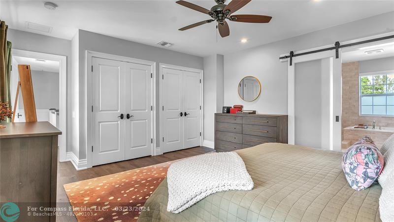 8585 Ranch Road Parkland, FL 33067 - Photo 33 of 69 a bedroom with a bed and a chandelier